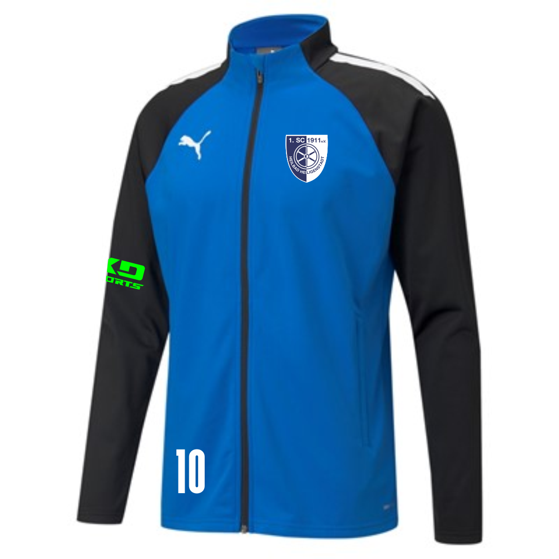 teamLIGA Kinder Training Jacke des 1. SC 1911 Heiligenstadt. Die Jacke ist blau mit schwarzen Ärmeln, hat weiße Details auf den Schultern, das weiße Puma Logo auf der Brust, das Wappen des 1. SC 1911 Heiligenstadt auf der rechten Brust, das grüne KD SPORT